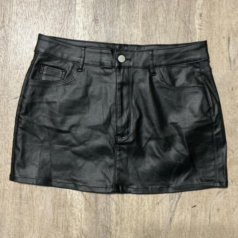 Black leather mini skirt with zipper and button closure. Size: XL
